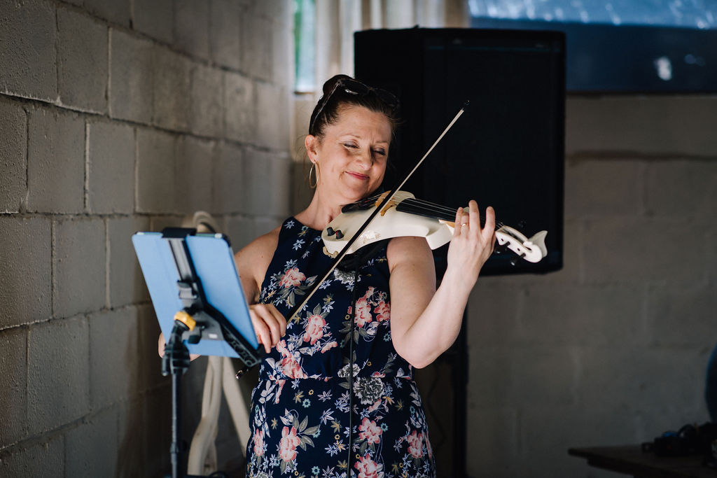 violinist playing modern classics for the bride and groom to walk down the aisle