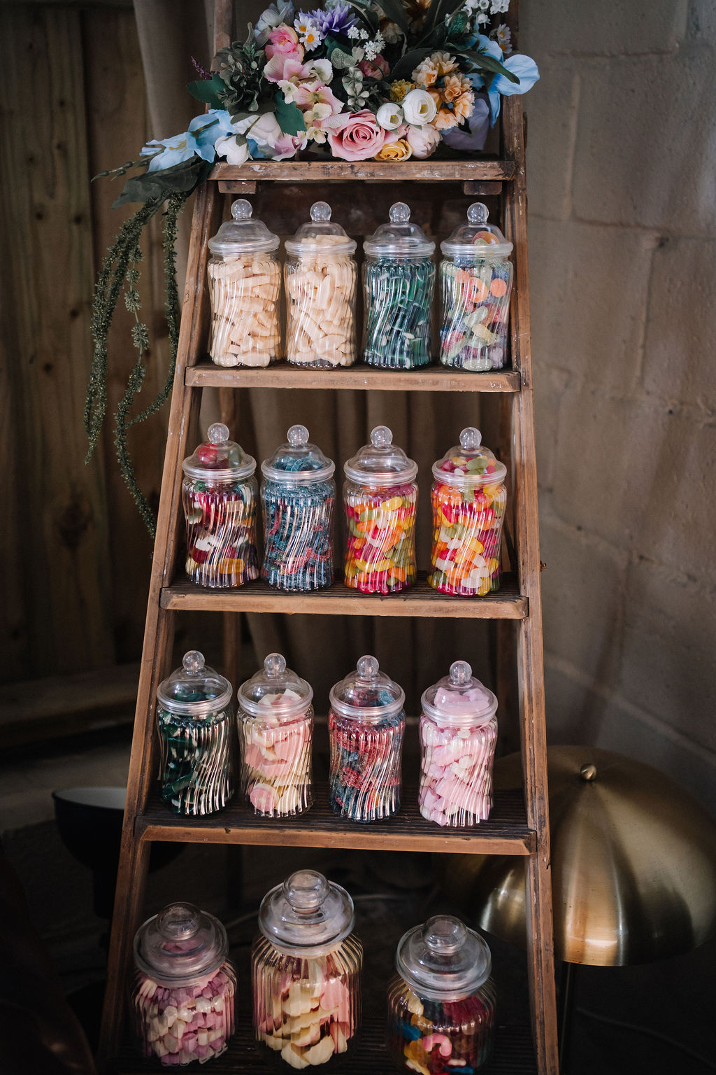 thrifted vintage ladder with sweet jars at DIY wedding