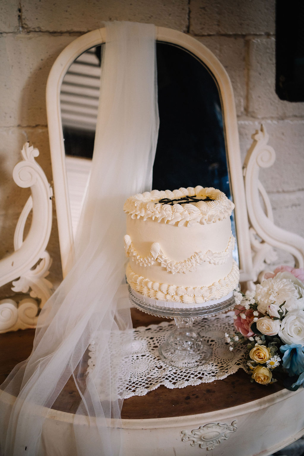 just married retro style wedding cake on vintage dressing table