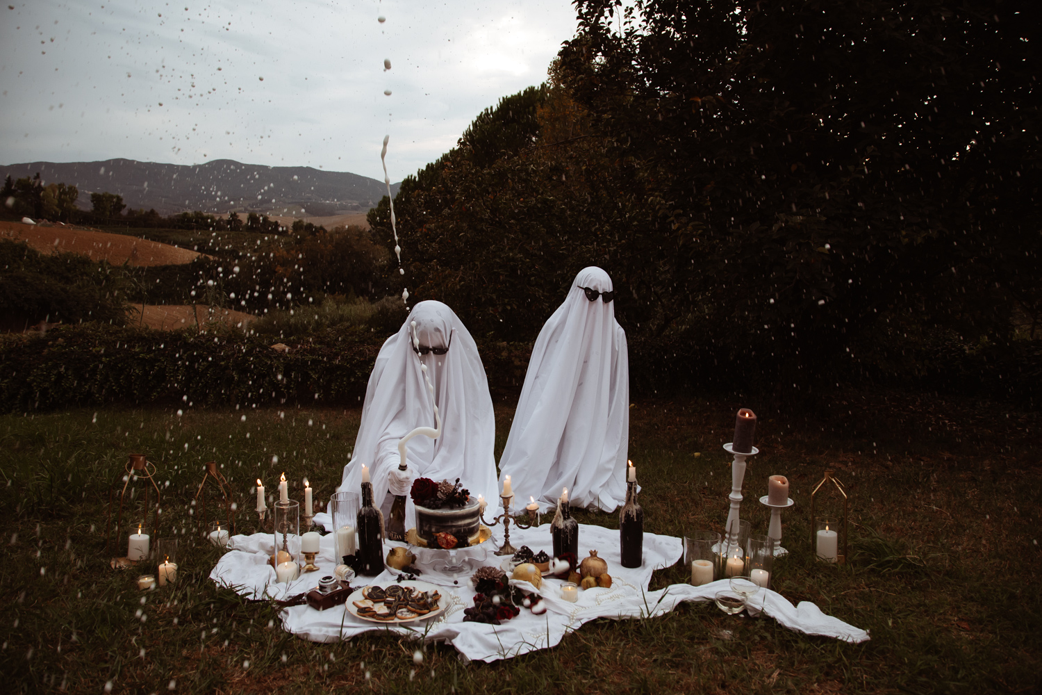 champagne flowing out of the bottle as groom ghost opens it for his bride ghost