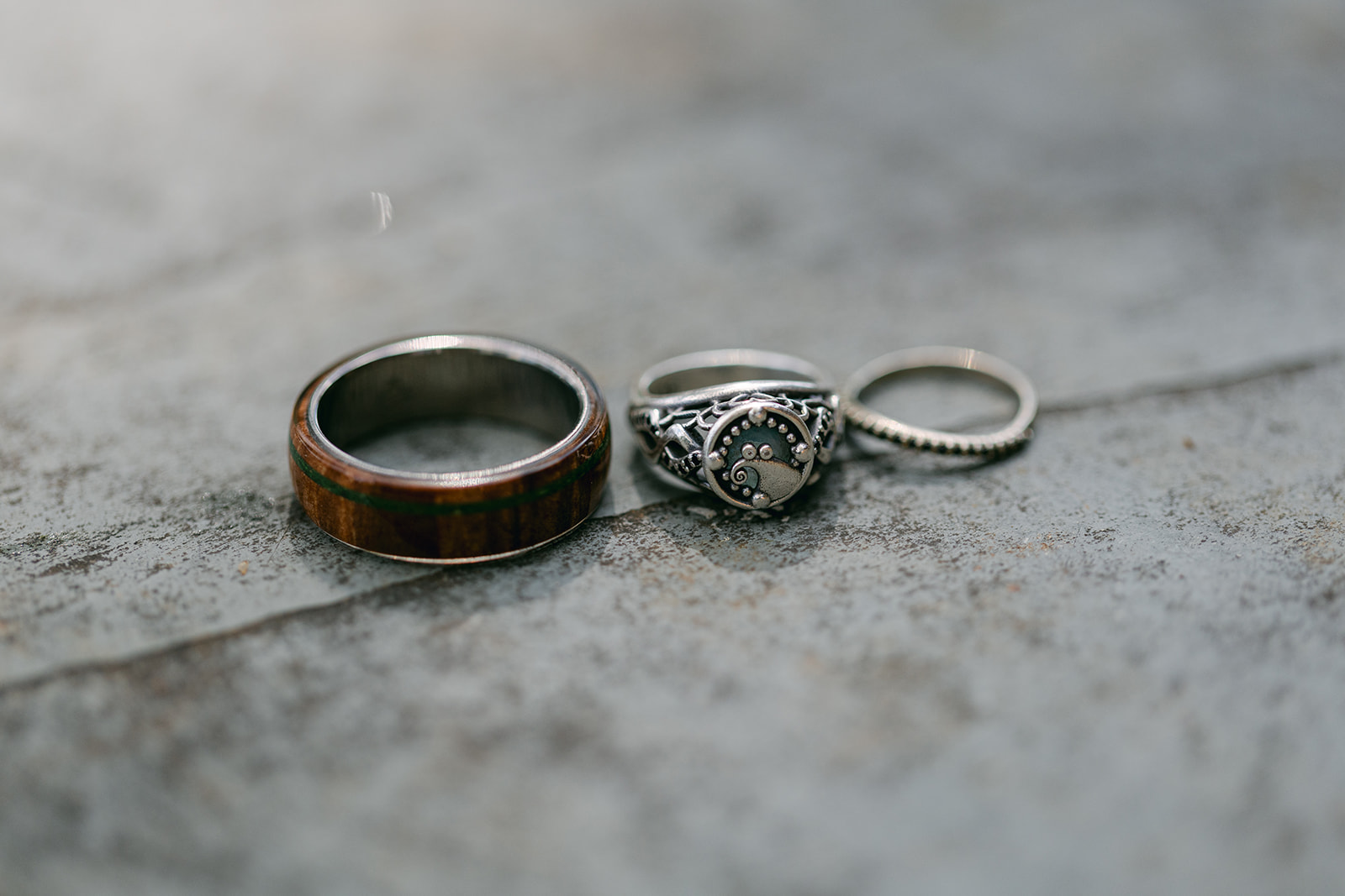 detail shot of bride and groom wedding rings - one inspired by the nightmare before Christmas