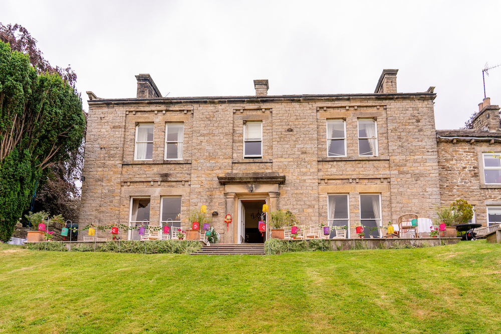intimate stone built wedding venue in Yorkshire decorated with colourful Chinese paper lanterns
