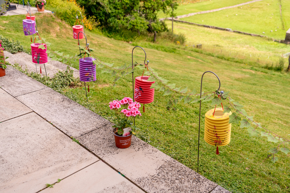 colourful Chinese paper lanterns holding a garland of leaves to decorate Yorkshire wedding venue