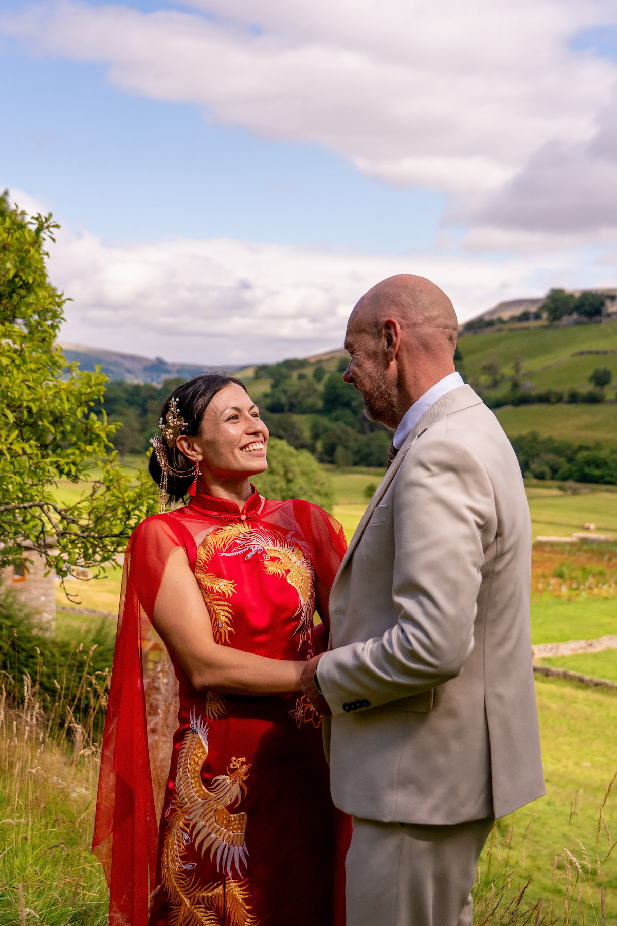 Bride wearing Chinese style red wedding dress with her husband at Yorkshire fusion wedding